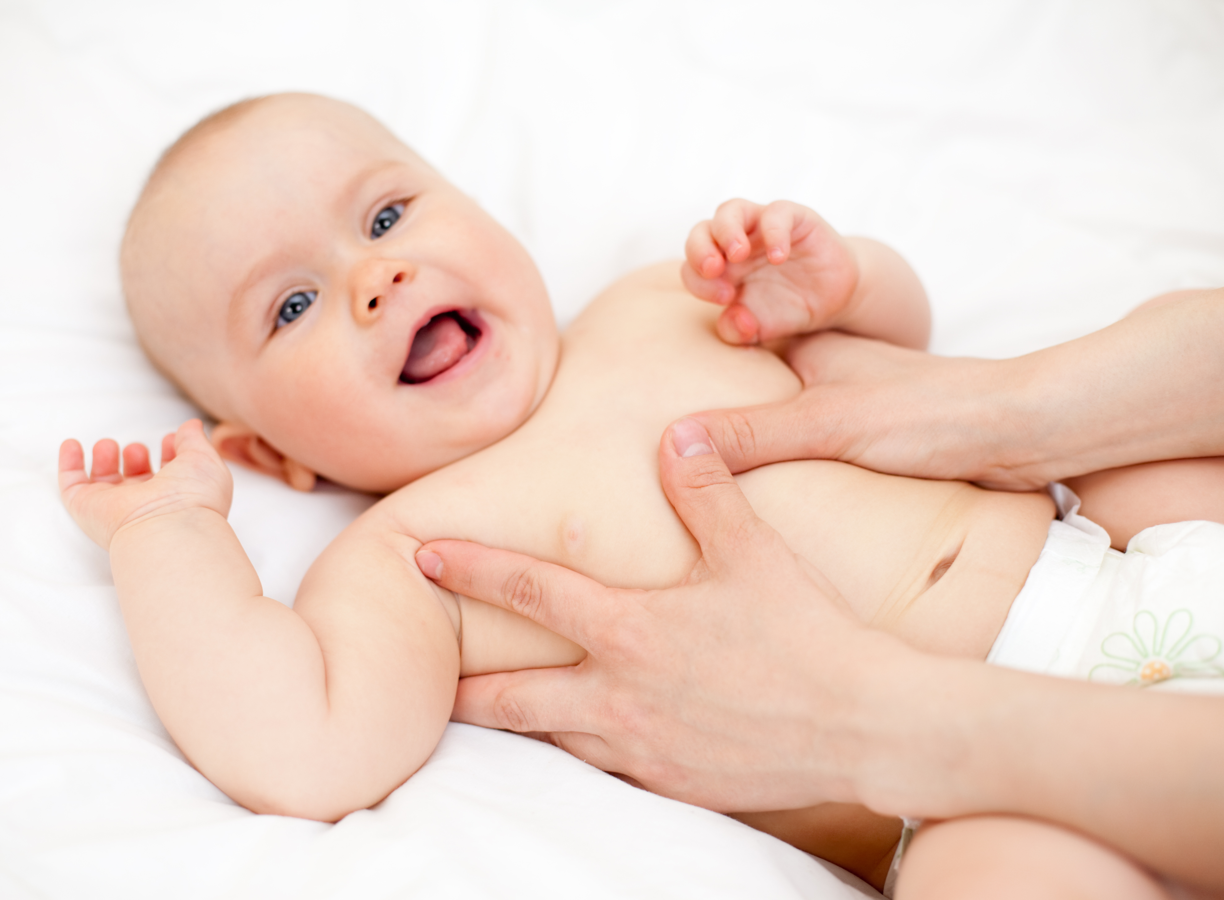 Masseuse massaging little baby girl, shallow focus